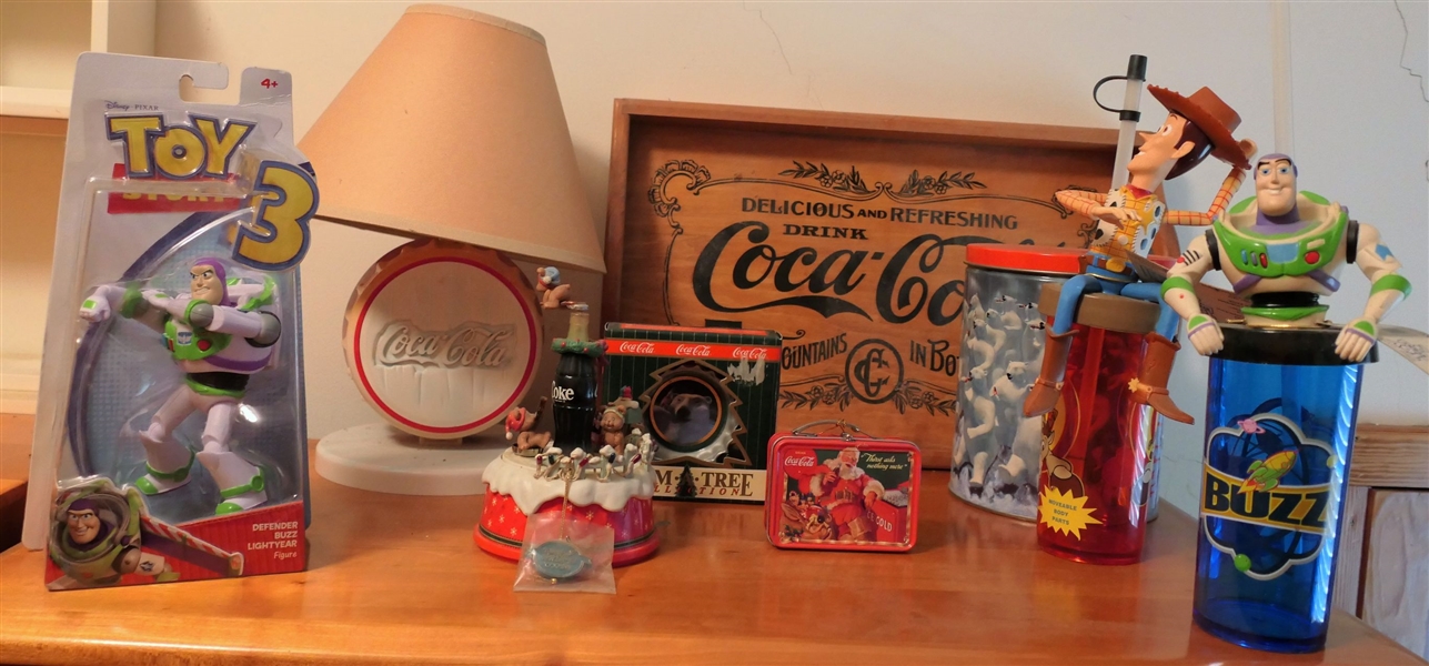 Coca Cola and Toys Story Items including Coca Cola Plastic Bottle Cap Lamp, Music Box, Wood Tray, Tins, Ornament, and Toy Story Cups and Buzz Lightyear