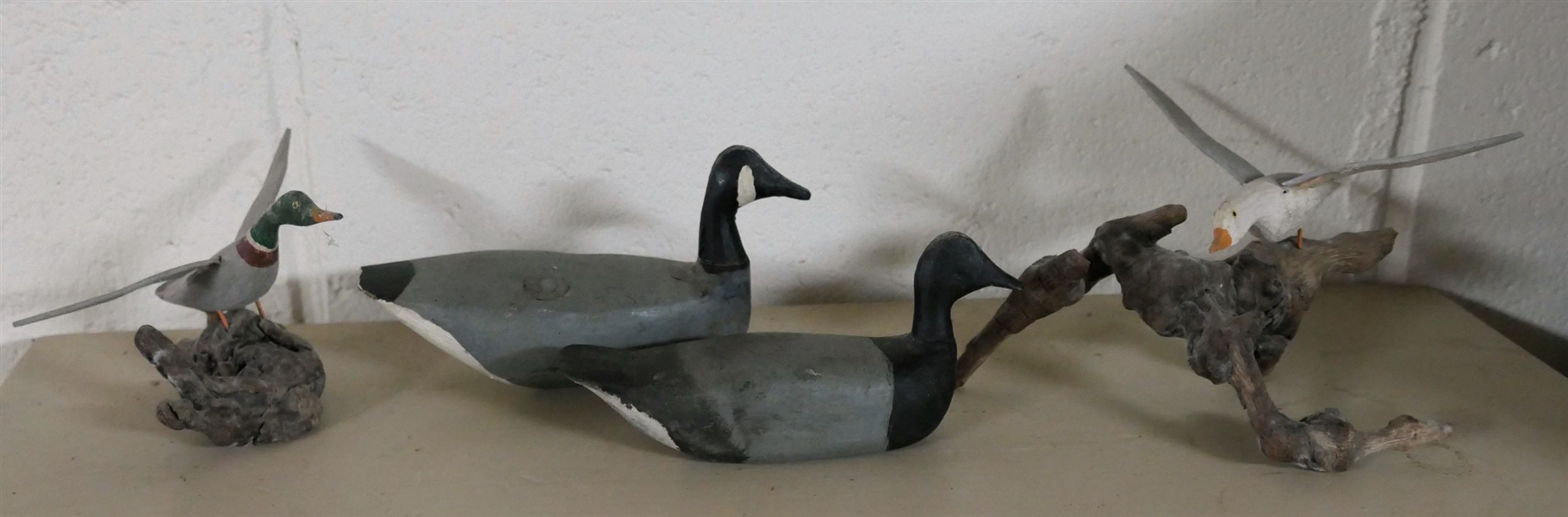 4 Hand Carved Wood Ducks and Sea Gull  - Gray and Black Ducks Measure 3" tall 5" Long - Sea Gull on Drift Wood Measures 4" tall 5" Across
