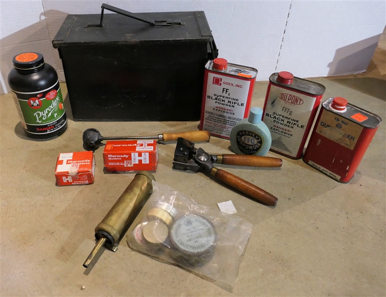 Ammo can with Bullet Molds, 1 Full Bottle of Powder, 1 Partial Tin of Powder, 2 Empty, Black Powder Primers, Partial Harveys Gun Powder Container, and Mini Balls