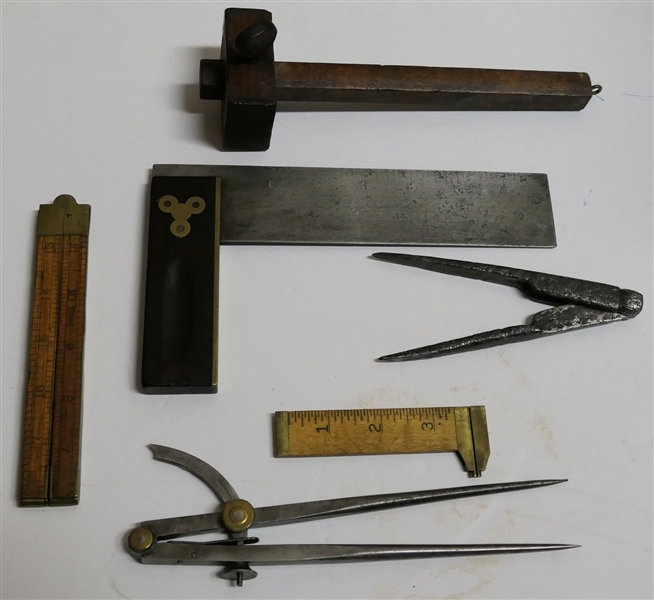 Lot of Antique Measuring Instruments including Hand Forged Compass, Wood Scribe, Stanley Folding Ruler, Smaller Stanley Brass Measurer, Metal Compass, and Wood Handled Square