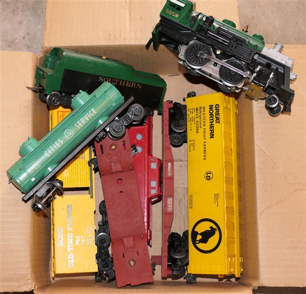 8 Lionel Train Pieces including Southern 8302 Engine, Cities Service Tanker Car, Southern Caboose, Great Northern Car, Pabst Blue Ribbon Car, and 2 Flat Trailers