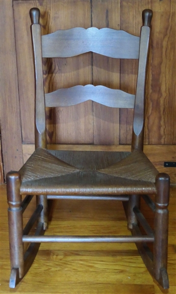Walnut Ladder Back Rocking Chair with Rush Bottom - Scalloped Slats on Back - Measures 33" tall 19" by 14 1/2" 