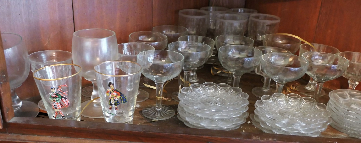 Shelf Lot including Glassware, Champagne Flutes, Goblets, and Soldier Glasses