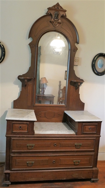 Walnut Victorian Marble Top Dresser with Mirror - 2 Candle Shelves - Wood Bust At Top Crest  - Hidden Drawer At Bottom - Measures 75" Tall 44" by 20" - Missing 1 Wood Block on Left Bottom Corner