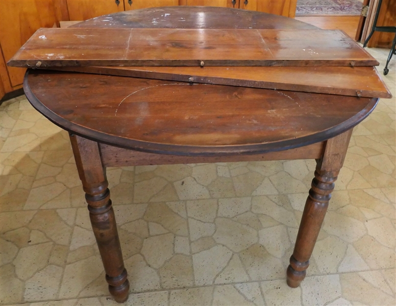 Oval Walnut Breakfast Table with 2 Leaves - Turned Legs - Measures 28" Tall 46 1/2" by 42" - Each Leaf Measures 11 1/2" - Finish Surface is a bit rough 