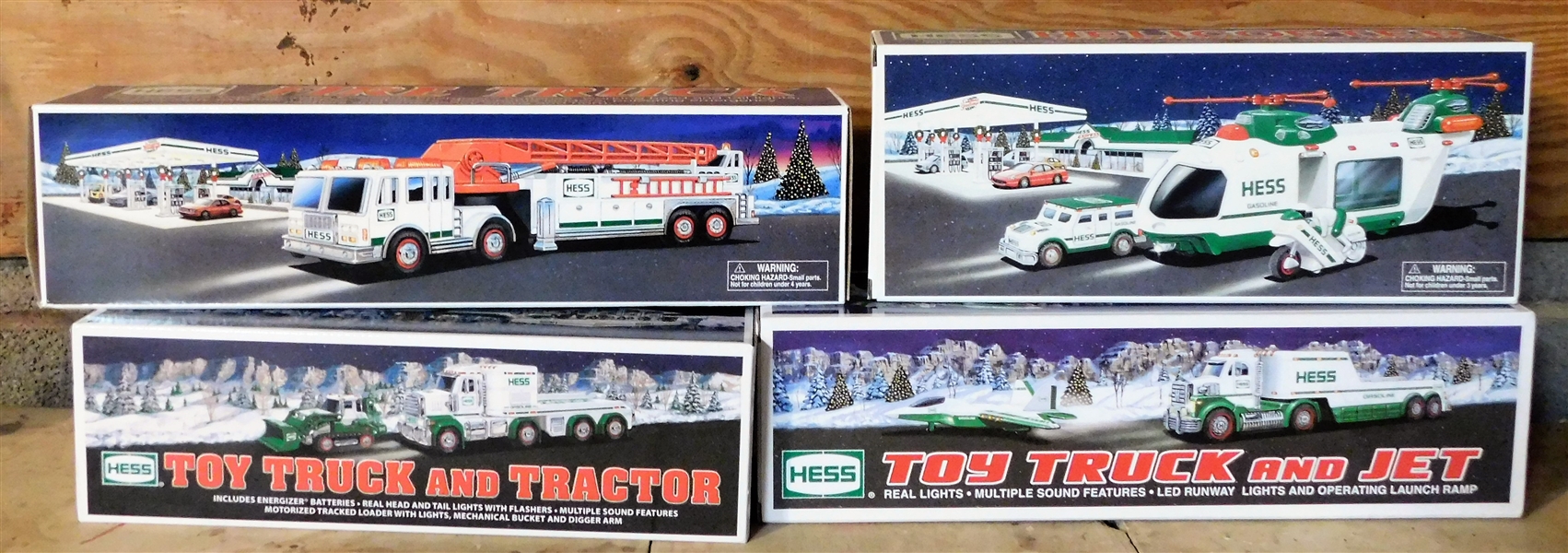 4 Hess Trucks including Toy Truck and Tractor, Fire Truck, Helicopter, and Toy Truck and Jet (2000, 2010, 2013, and 2001)