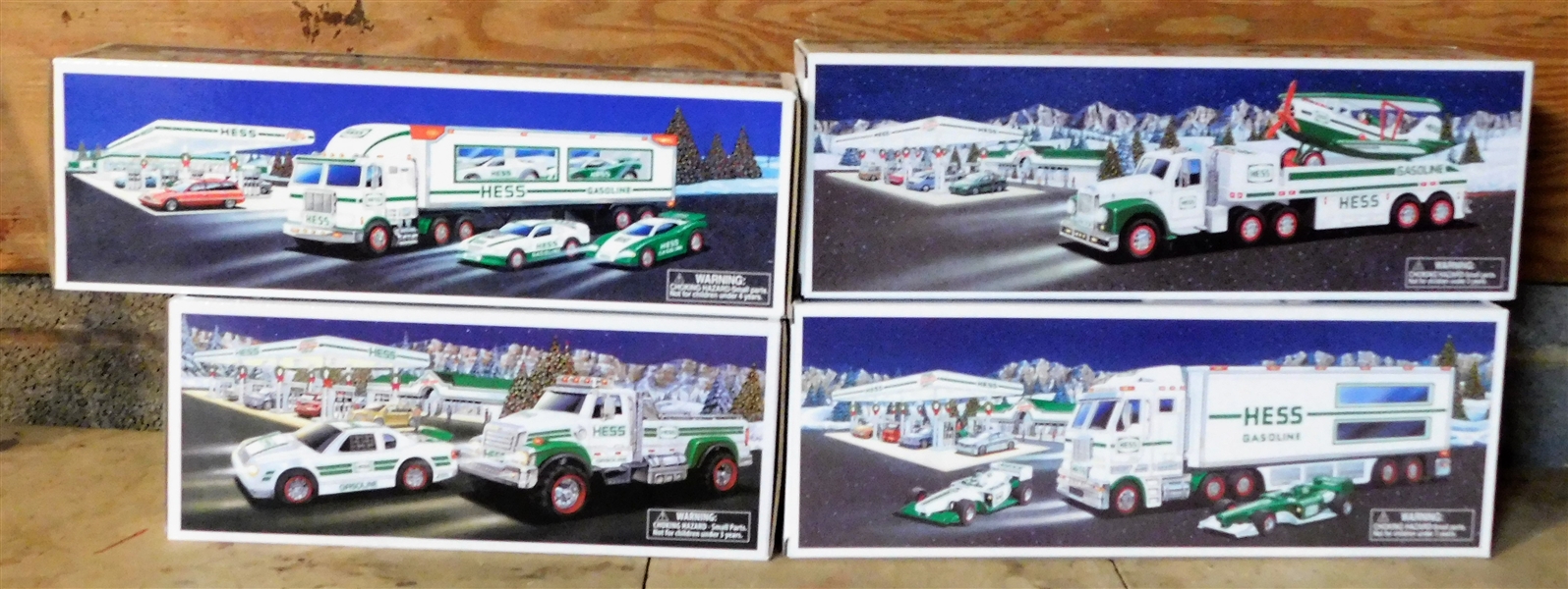 4 Hess Trucks including 2003 Toy Truck and Race Cars, 2011 Toy Truck and Race Car, 2002 Toy Truck and Airplane, and 1997 Toy Truck and Racers