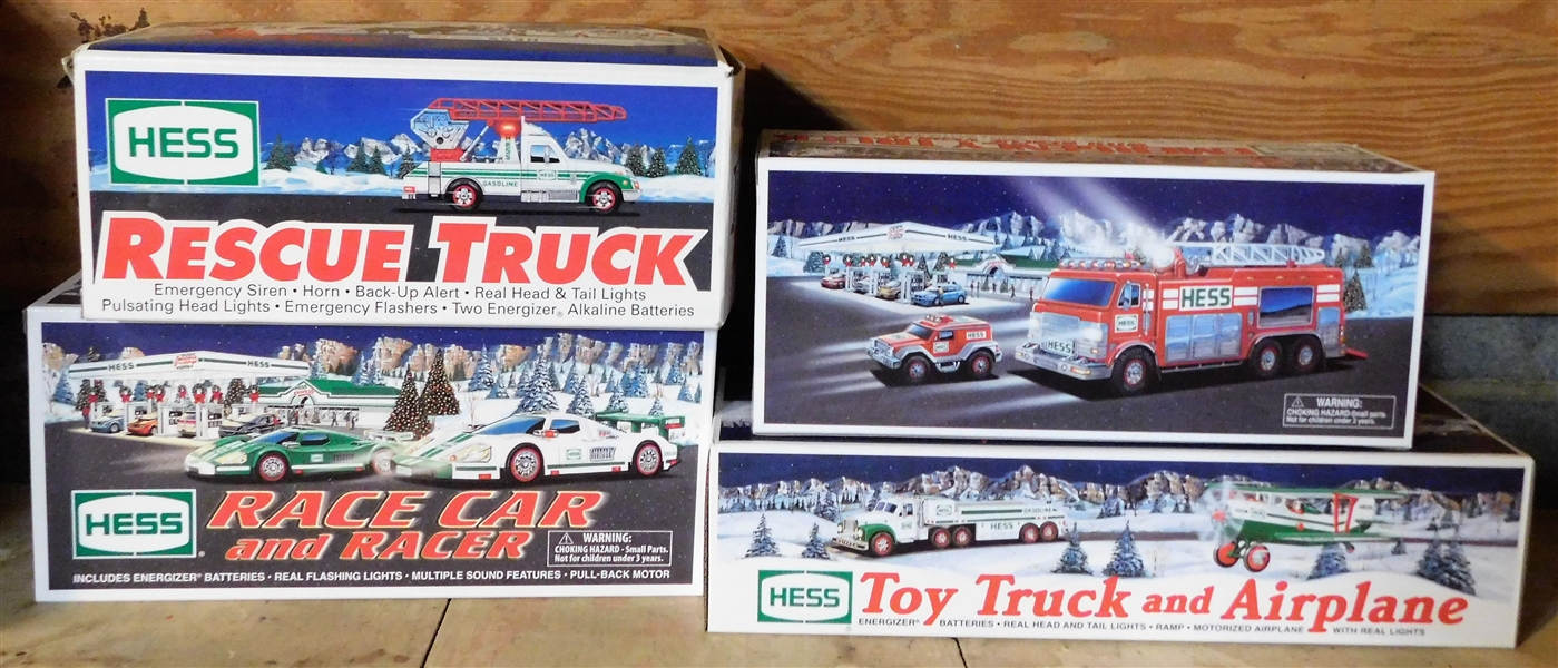 4 Hess Trucks including 2002 Toy Truck and Airplane. 2005 Emergency Truck, 1994 Rescue Truck, and 2009 Race Car