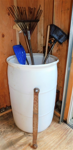 Plastic Barrel with Rake, Golf Clubs, Paddle, and Stabilizer Bar