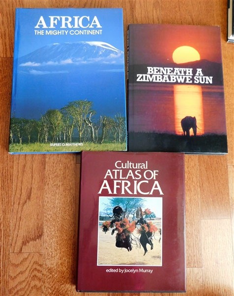 "Africa The Mighty Continent" by Rupert O. Matthews, "Cultural Atlas of Africa" by Jocelyn Murray, and "Beneath A Zimbabwe Sun" - Hardcover Books