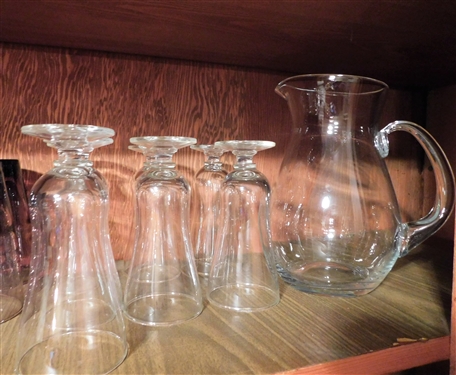 2 Shelves of Glassware including Pink, Purple, Green, and Clear 