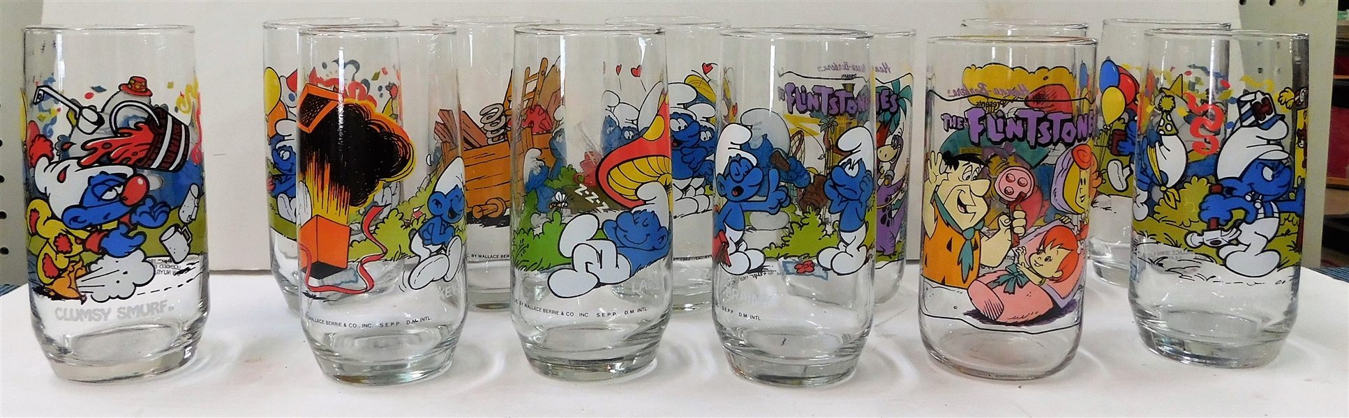 13 Smurf Glasses and 2 Flintstones Glasses 