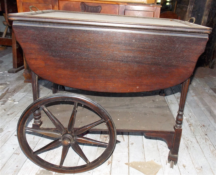 Rolling Wood Tea Cart with Glass tray Top - Front Leg Needs Repair and Needs Dusting - Finish is Ok - Measures 27" tall 28 1/2" by 17 1/2"