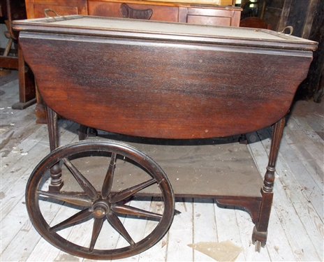 Rolling Wood Tea Cart with Glass tray Top - Front Leg Needs Repair and Needs Dusting - Finish is Ok - Measures 27 tall 28 1/2 by 17 1/2