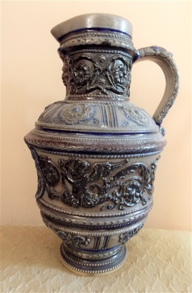 German Stoneware Pitcher with Castle, Cherubs, North Wind Face, and Flowers - Number 03 on Bottom - Measures 10 1/2" Tall