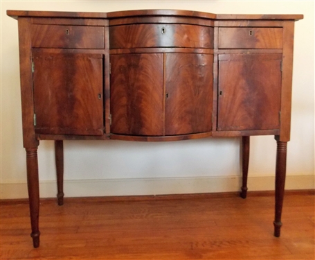 Small Sheraton Bow Front Sideboard - Circa 1820-1830 - Flame Grain Mahogany - Dovetailed Drawer - Some Veneer Loss -Brass Key Holes -  Measures - 40" tall 46 1/2" by 21 1/2" NO CONTENTS