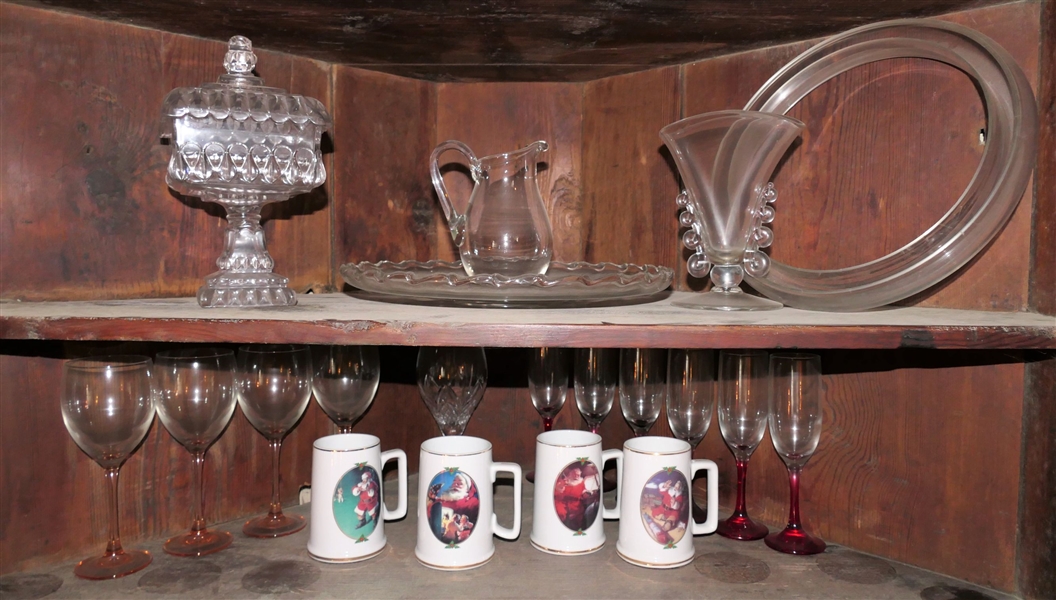2 Shelves of Glassware including Heisey, Fostoria, Compotes, Coca Cola Santa Mugs, Pink and Red Stems