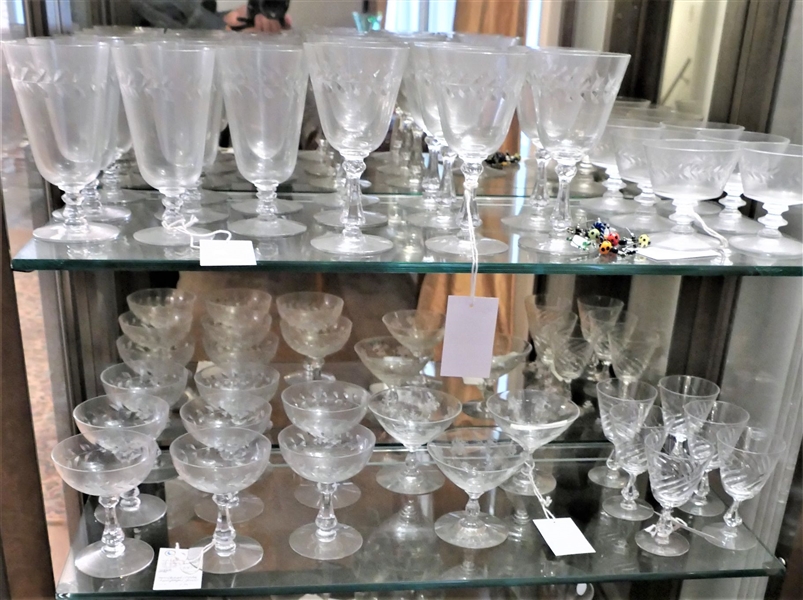2 Shelves of Glassware including Fostoria Swirl Glasses, Chintz Champagne Coupes, and Lots of Holly Etched Glasses 
