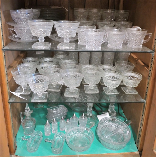 Large Lot of Cape Cod Glassware including Mugs, Cups and Saucers, 8 1/8" Plates, Champagne Flutes, Sherbets, Divided Bowls, Candle Sticks, Ashtrays, Shakers, Cruets, and Others