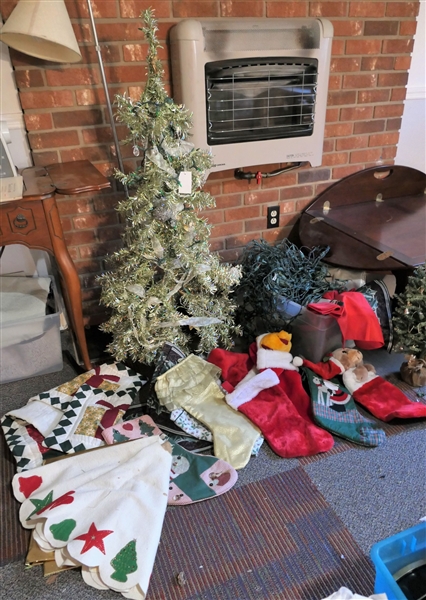 Lot of Christmas Items including Tree Skirts, Stockings, Lights, Gold Tinsel Tree, Table Top Tree, and Linens