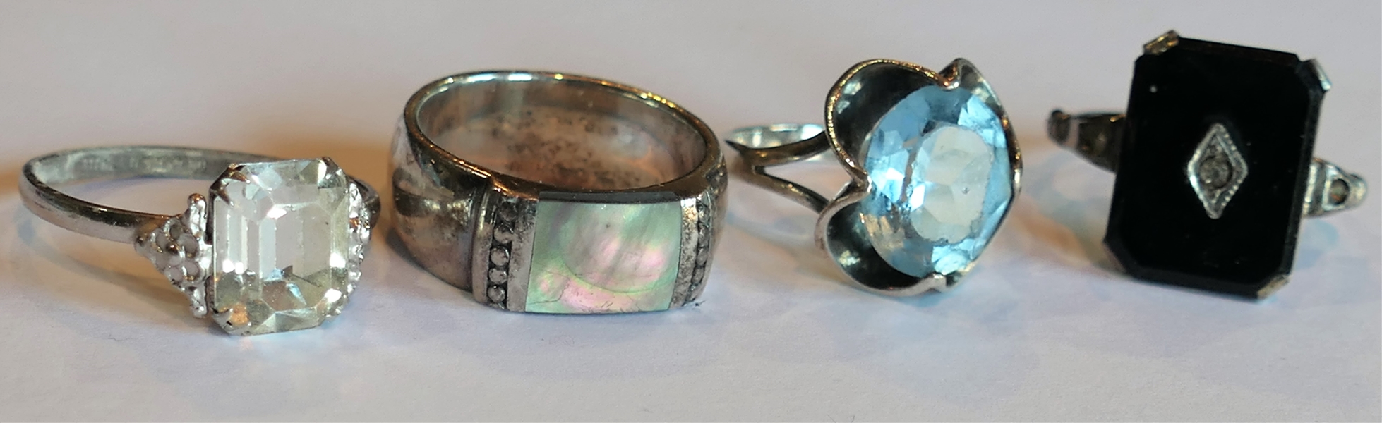 4 Sterling Silver Rings - Mother of Pearl Band Size 7, Blue Faceted Stone Size 7, Clear Stone Size 8, and Black Stone Adjustable Size 