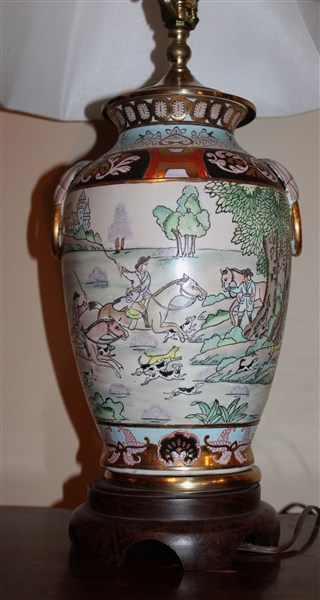 Beautiful Asian Urn Style Porcelain Lamp with Horseback Hunt Scenes - Brass Top and Wood Bases - Measures 19" To Bulb - Carved Stone Finial 