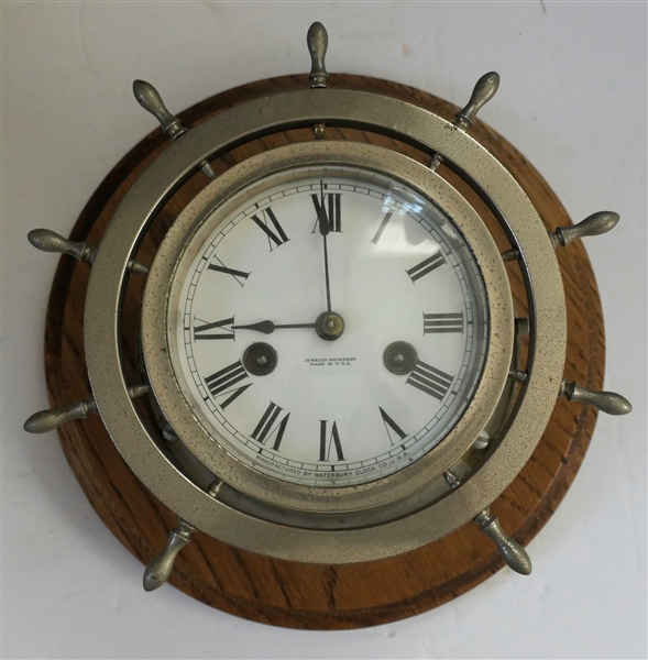 Waterbury Clock Co. Jeweled Movement Ships Clock - Ship Wheel Shape on Oak Plaque - Clock Measures 8" Across
