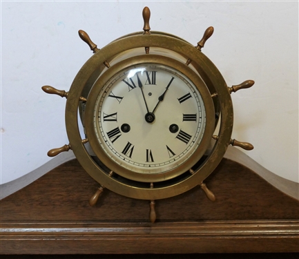 Brass Ship Wheel Ship Clock (Waterbury?) in Mahogany Stand - Clock Measures 8 Across - Holder Measures 18 by 3 1/2 