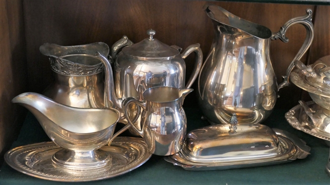 Shelf Lot of Silverplate Items - Pitchers, Tea Pots, Gravy Boats, Coasters, Covered Dishes, Butter Dish, Basket, and Coasters