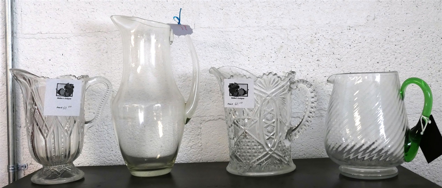 4 Clear Glass Pitchers - 2 Early American Press Glass, Clear Swirl with Applied Green Handle, and Tall Clear Pitcher - Tallest Measures 12" tall - Green Handle Measures 7" Tall 
