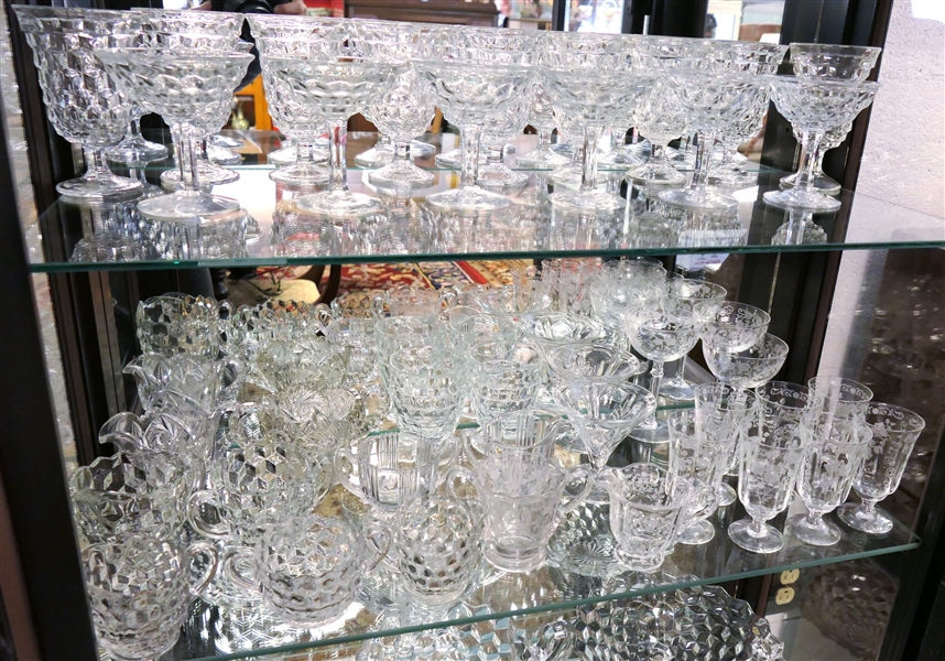 2 Shelves of Clear Glassware including American Fostoria Champagnes, American Fostoria Iced Teas, American Fostoria Cream & Sugars, Elegant Etched Glass Pieces, and Press Glass Cream and Sugar