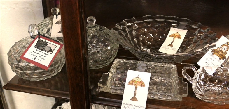 2 Shelves of Glassware including Mostly Early American Fostoria - Footed Bowls, Butter Dishes, Covered Candy Dishes, Pitcher,  Footed Vase, and Oval Divided Bowls