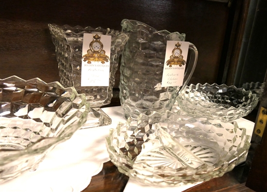 2 Shelves of Glassware including Mostly Early American Fostoria - Footed Bowls, Butter Dishes, Covered Candy Dishes, Pitcher,  Footed Vase, and Oval Divided Bowls