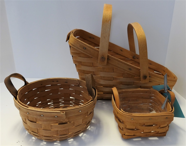 3 Longaberger Baskets  Smallest with Plastic Liner and Leather Handles - Round with Leather Handles, and Larger Angled - Largest Measures 8" tall 13" by 8"