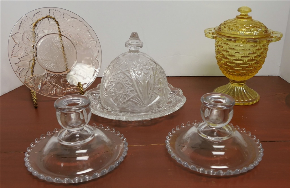 5 Pieces of Depression Glass including Amber Candy Jar, Pink 7" Plate, Butter Dish, and Pair of 3" Candle Sticks
