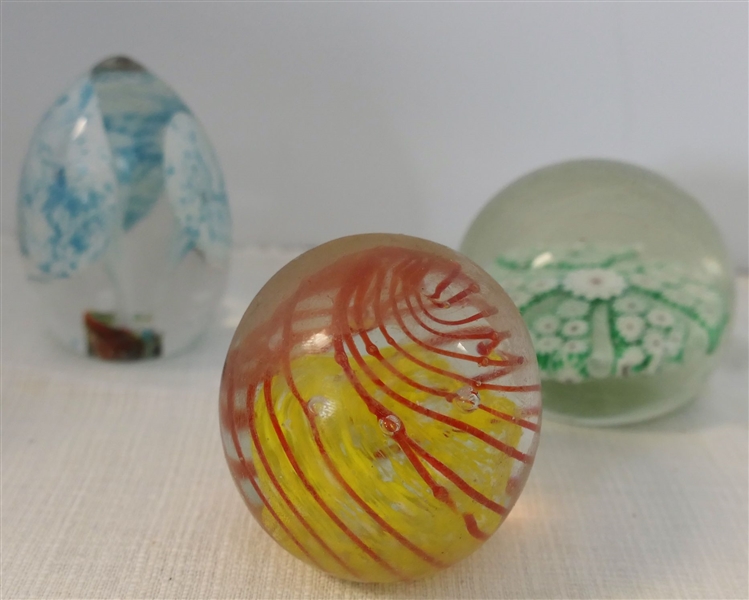 3 Art Glass Paper Weights Oval with Blue and White Flowers, Green and White Flowers, and Yellow and Orange Swirl - Oval Shaped Measures 3 1/4" Tall 