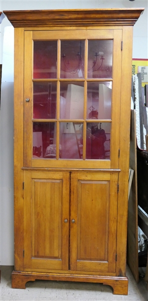 Nice Country Style Pine Corner Cupboard - Paneled Lower Doors - 9 Glass Pane Upper Door - Crown Molding - Red Painted Interior - 2 Shelves - Measures 88 1/2" tall 36 1/2" by 20" 