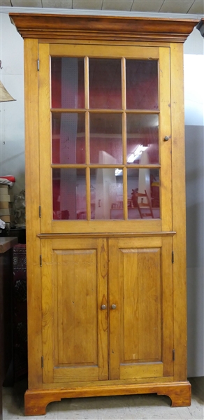 Nice Country Style Pine Corner Cupboard - Paneled Lower Doors - 9 Glass Pane Upper Door - Crown Molding - Red Painted Interior - 2 Shelves - Measures 88 1/2" tall 36 1/2" by 20" 
