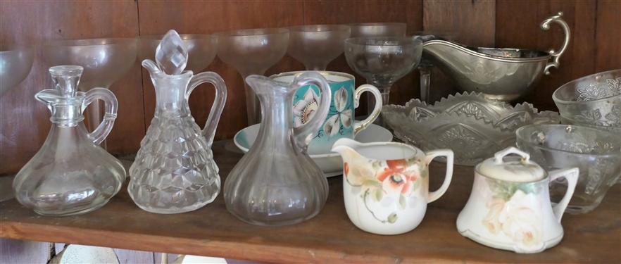 Shelf Lot Including Cruets, China, Glassware, Champagne Coupes, and Silverplate Gravy Boat