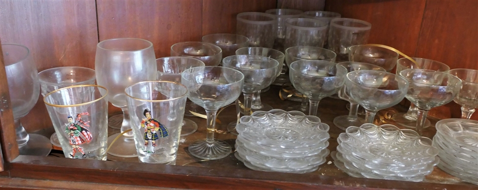 Shelf Lot including Glassware, Champagne Flutes, Goblets, and Soldier Glasses