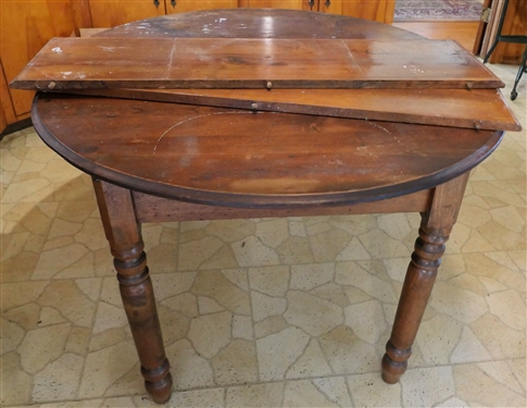 Oval Walnut Breakfast Table with 2 Leaves - Turned Legs - Measures 28 Tall 46 1/2 by 42 - Each Leaf Measures 11 1/2 - Finish Surface is a bit rough 