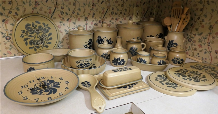 25 + Assorted Pieces of Pfaltzgraff Folk Art Stoneware / Accessories including Burner Covers, Butter Dish, Wall Clock, Canister Set, Cream Pitcher, Several Sugar Bowls, Trivet, Vase, and Utensil...