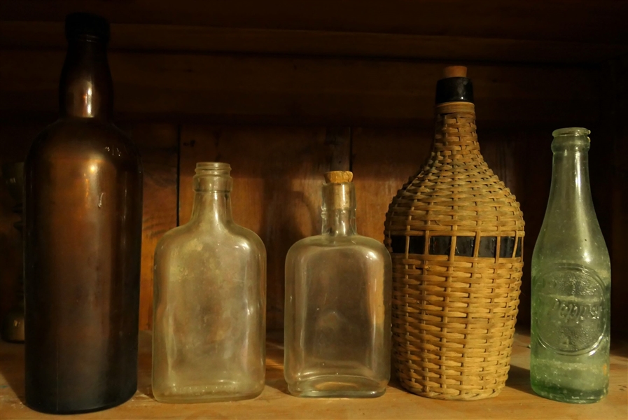 5 Bottles including Brown W. Harper in Wicker Holder, Roanoke VA Dr. Pepper, 2 Clear Flask Bottles, and Brown 4/5 Quart Bottle