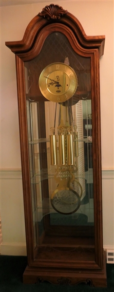 Ridgeway Lighted Display Clock - Beveled Glass Door - Unusual Glass Pendulum - Brass Weights and Face, Second Register and Moon Phase -Glass Display Shelves Inside -  Clock Measures 84" Tall 27" by...