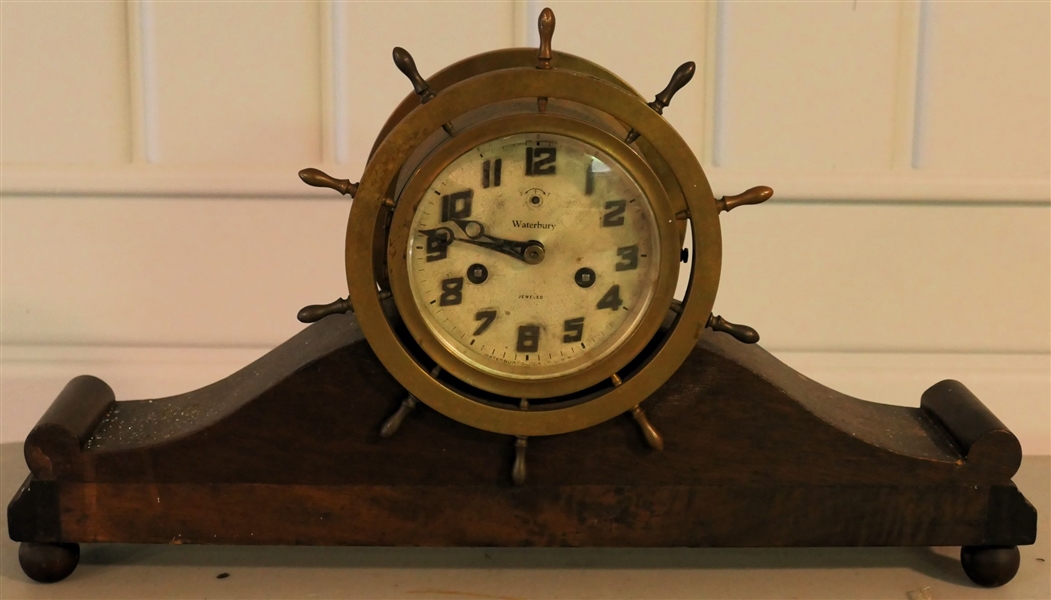 Brass Waterbury Ships Wheel Clock in Mahogany / Burl Stand - Measures 10 1/2" tall 18" Across