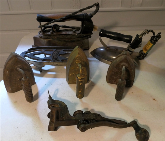 Lot of Irons including Dover Trivet, 3 Flat Irons, 2 Electric Irons, and Quicksafe Mfg. Co. Can Opener 