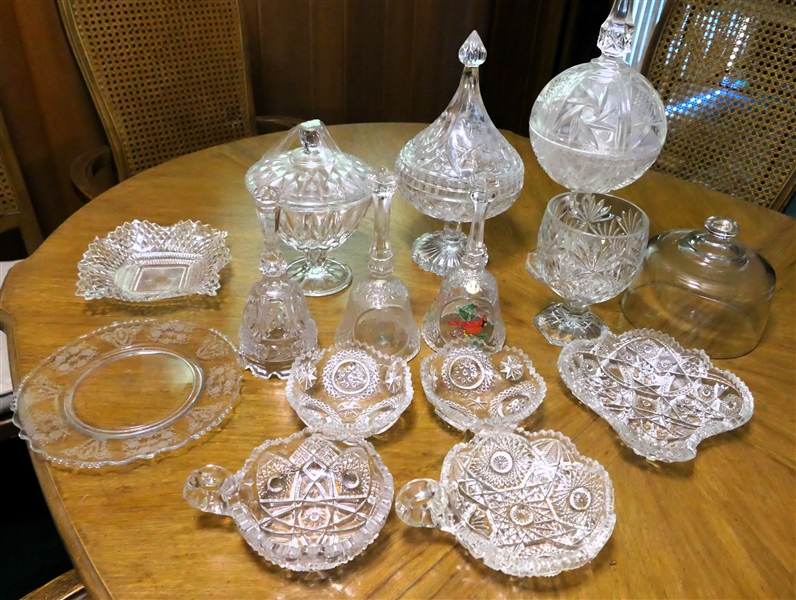 Lot of Clear Glassware including Press Glass Nappys, Crystal Bells, Tiffin Cherokee Rose Plate, Clear Butter Dome, Oversized Candy Dish, and Compotes - Largest Candy Dish Measures 15" Tall 