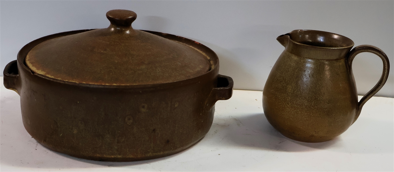 2 Pieces of North Carolina Pottery - Lidded Dish with Double Handles - Measuring 3 1/2" Tall 9" Across and Pitcher Measuring 5" Tall - Both Pieces Have Some Chips and Flakes 