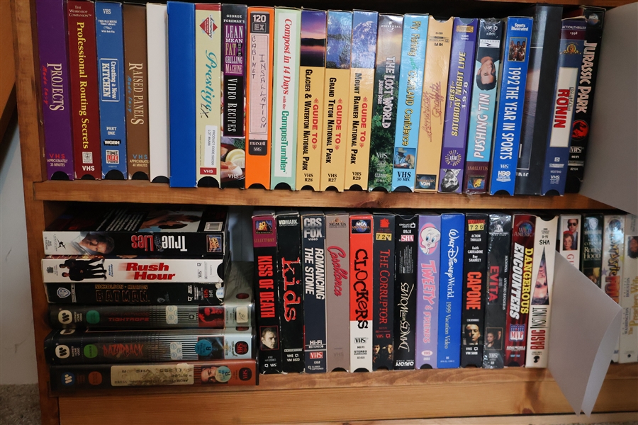 Lot of VHS Movies including "Jurassic Park" "Cluckers" "Rush Hour" Wood Working Projects, and Guides to National Parks