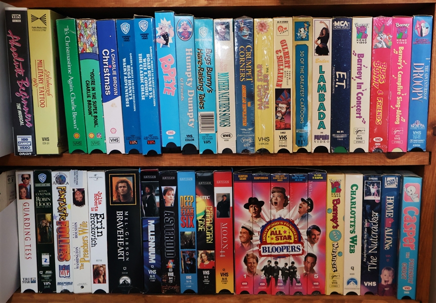 Lot of VHS Movies including "Barney" "ET" "Braveheart" " All Star Bloopers" "Casper